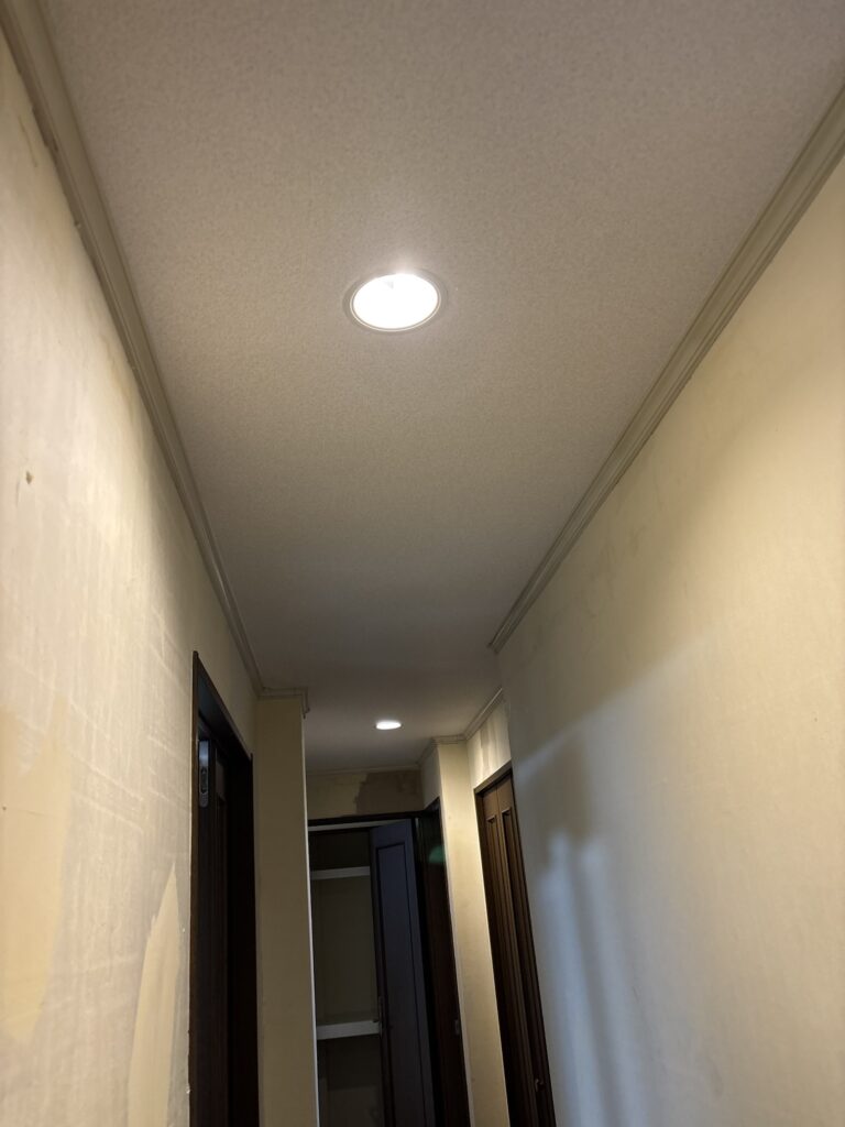Finished embossed wallpaper on a condominium hallway ceiling