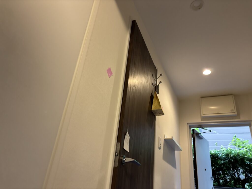 Hallway wall in a first-floor condominium apartment before removing the existing wallpaper.