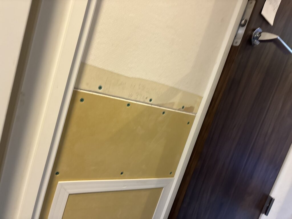 Newly installed gypsum board covering part of the kitchen ceiling following water damage from a pipe leak.