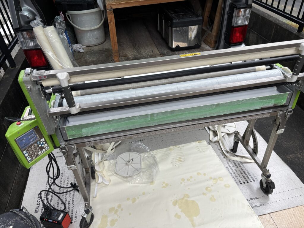 Wallpaper being prepared with a wallpaper pasting machine.