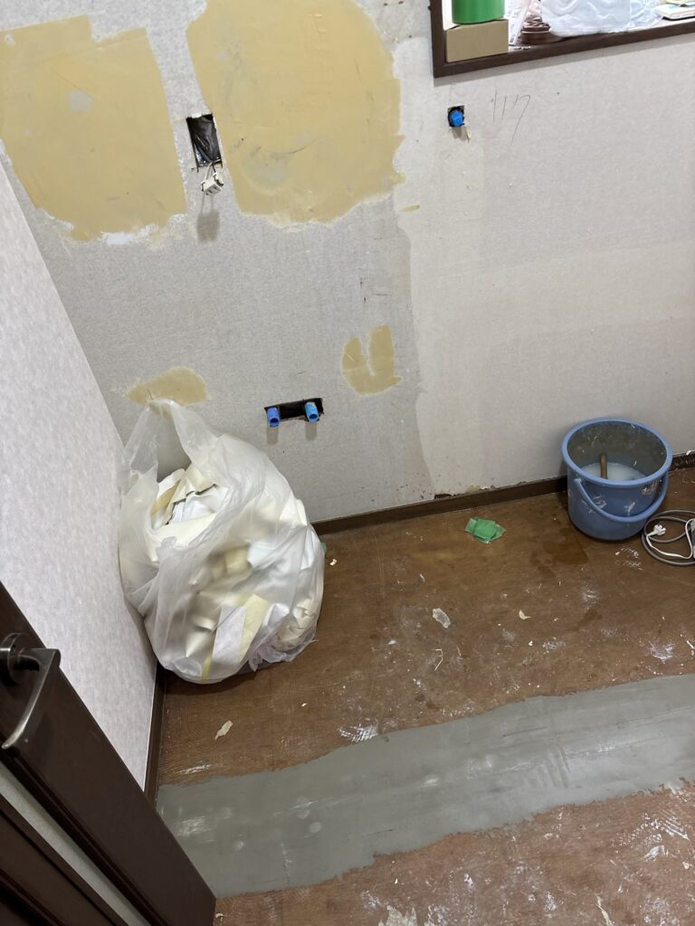 Finishing coat of joint compound applied to a repaired wall section.