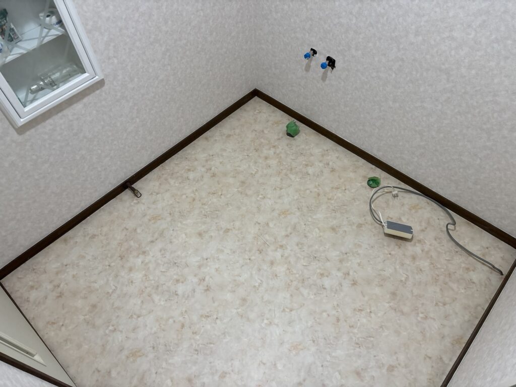 Close-up of completed washroom cushion flooring with clean edges.