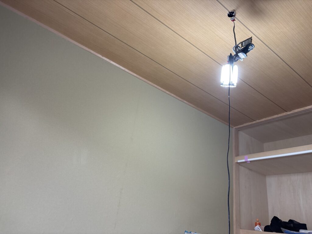 Completed ceiling and wall wallpaper installation in a Japanese-style room.