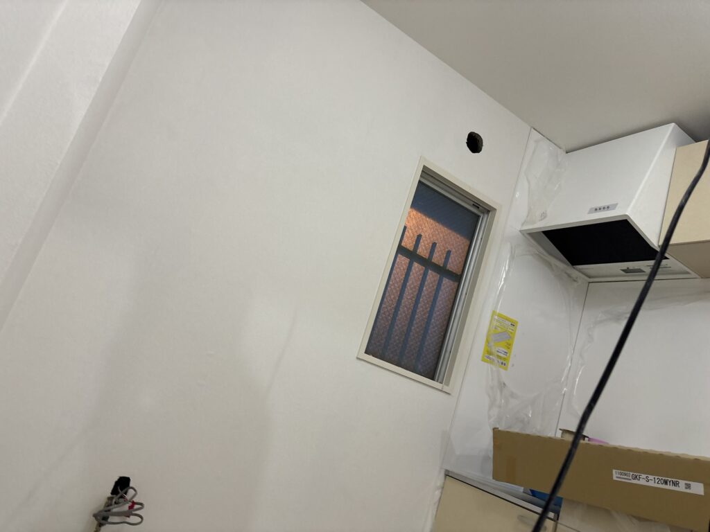 Finished wallpaper installation in the kitchen area of a renovated condominium.