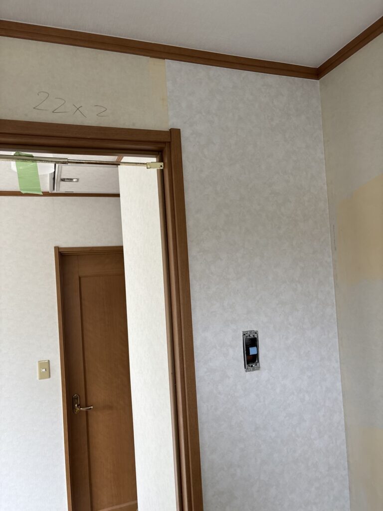Wallpaper being installed on a washroom wall