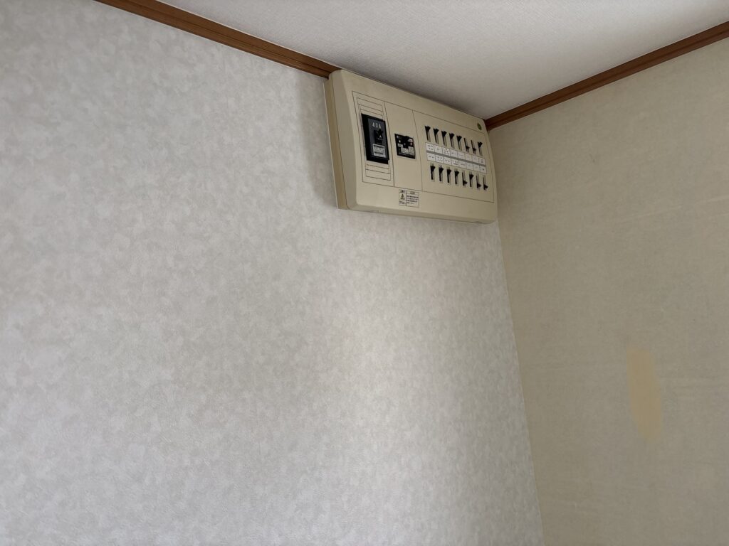 Finished wallpaper installation around the electrical distribution panel
