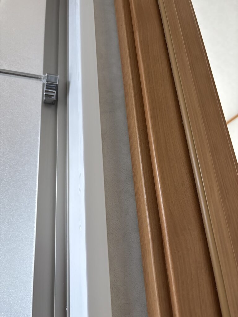 Completed wallpaper installation between the bathroom and washroom door frames