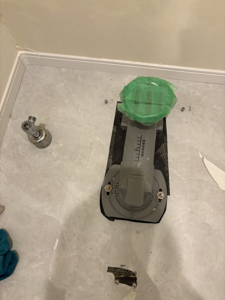 Drain flange exposed after removing a toilet in a commercial bathroom