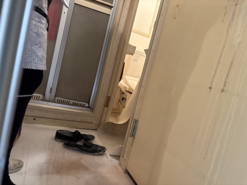 Cushion flooring being installed around the toilet