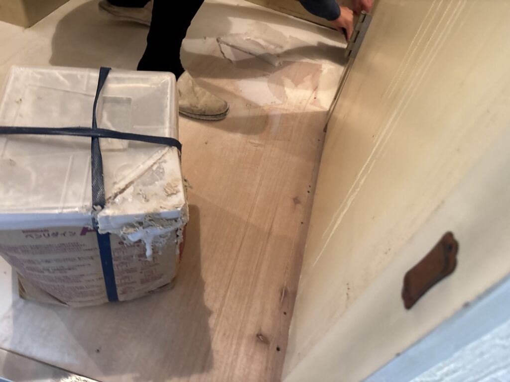 Flooring adhesive being applied to the washroom subfloor