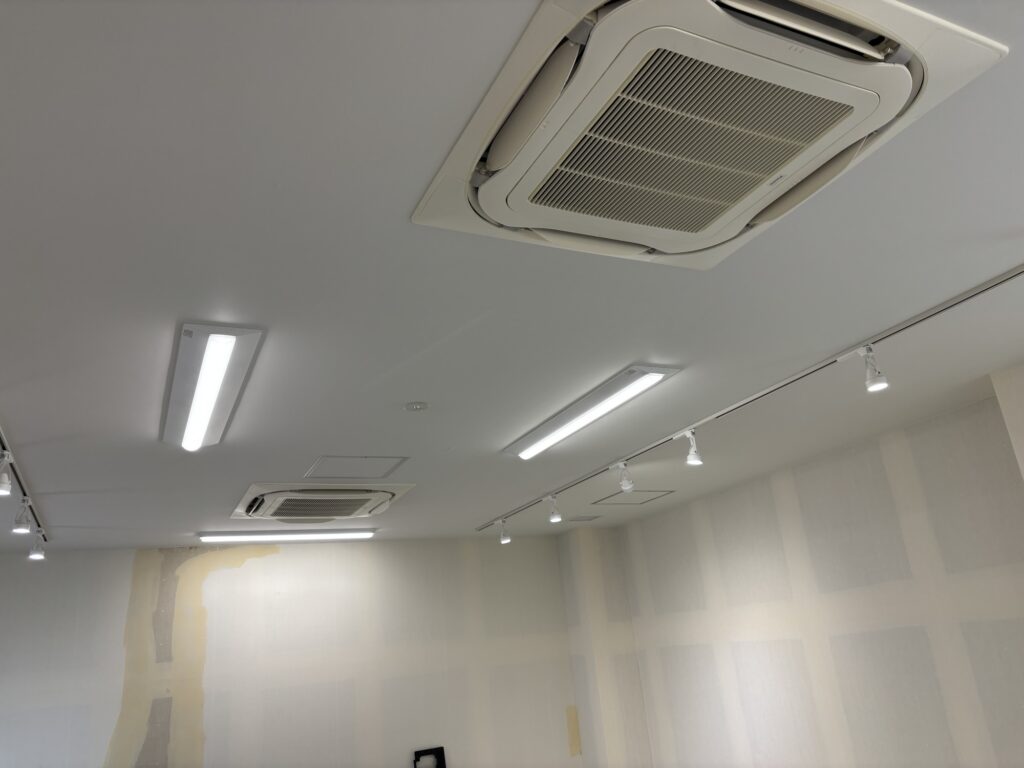 Wide view of the finished white ceiling wallpaper in a commercial interior.