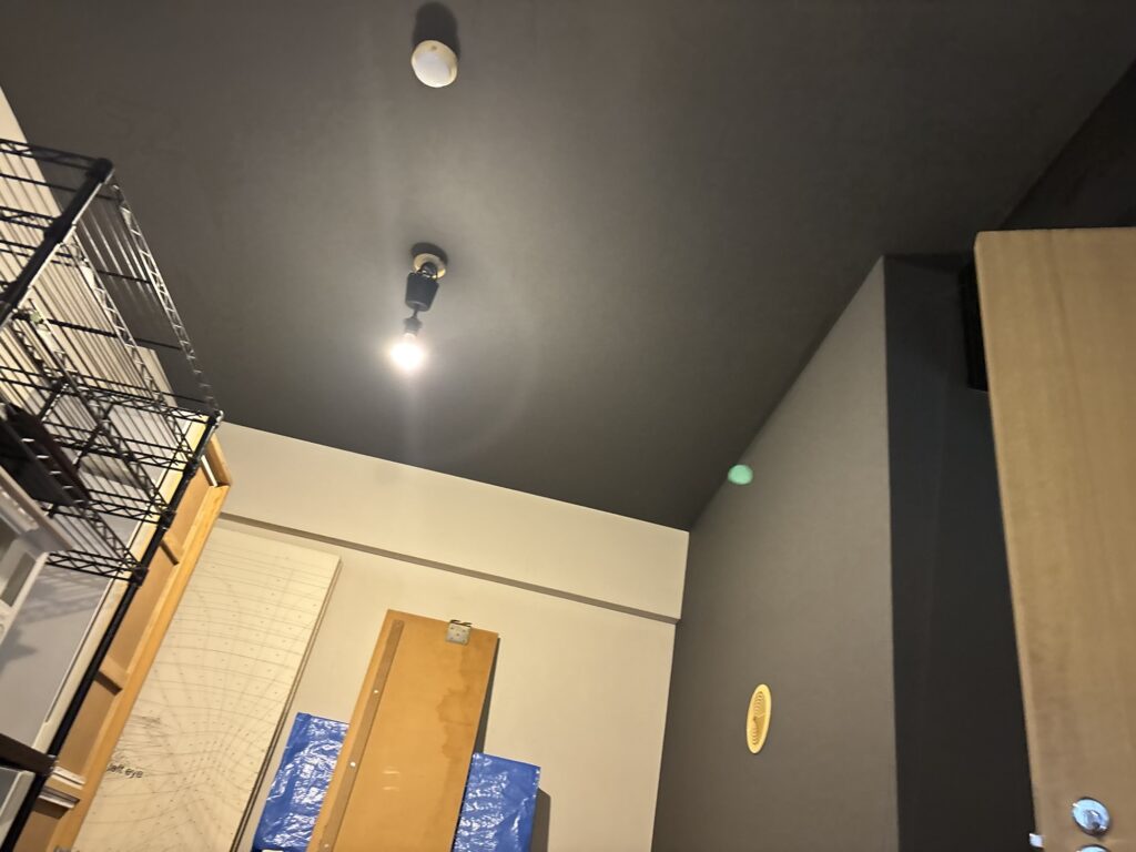 Finished living room with newly installed black wallpaper after the renovation.