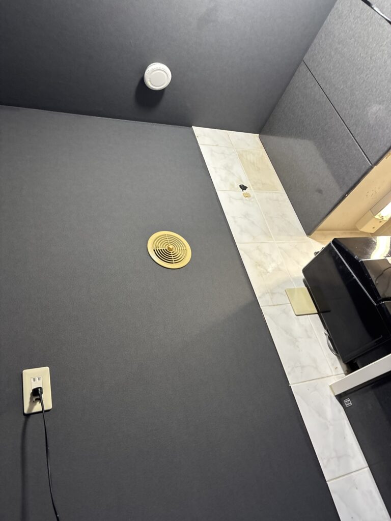Kitchen with newly installed black wallpaper on the walls and ceiling.