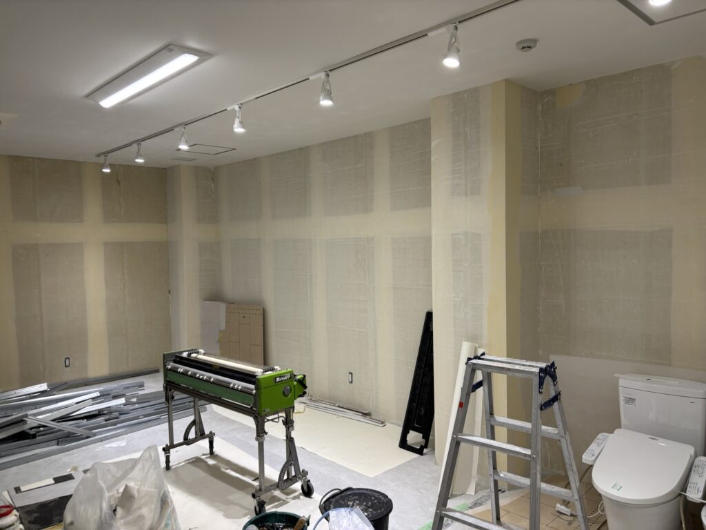 Commercial room with prepared wall surfaces before wallpaper installation during a restoration project in Japan.