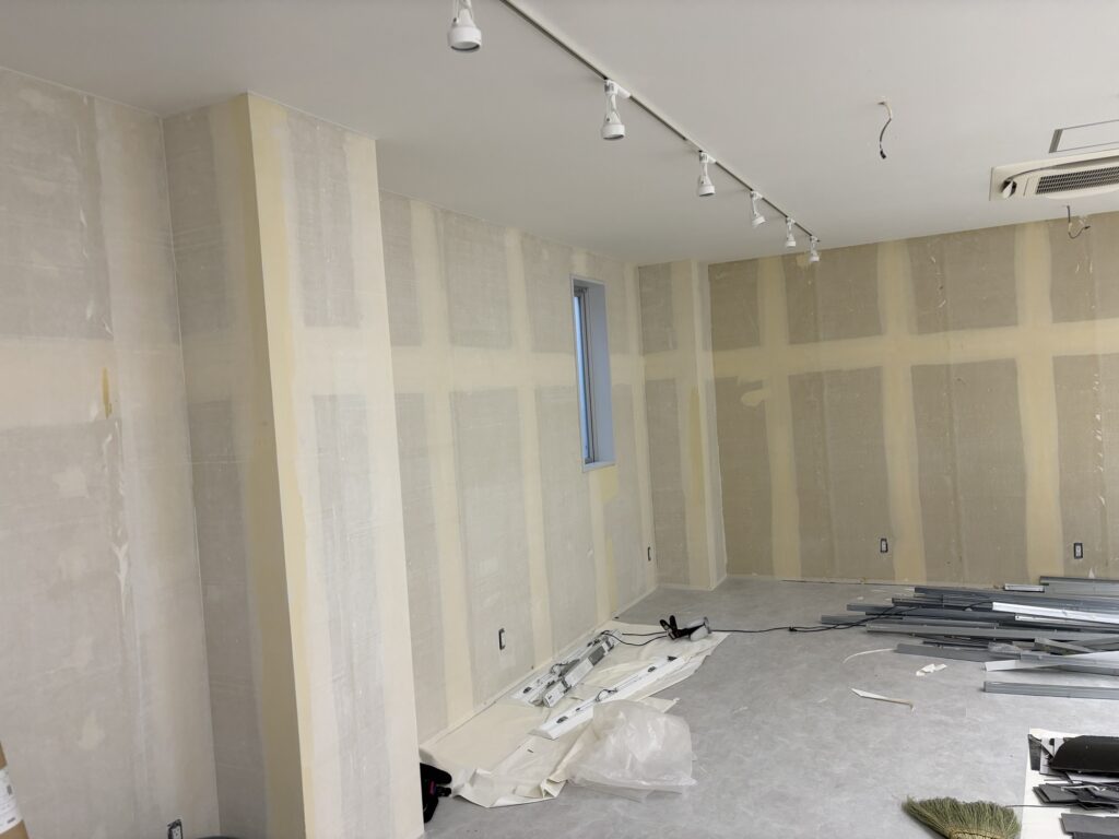 Interior of a commercial space showing puttied walls before new wallpaper is installed.