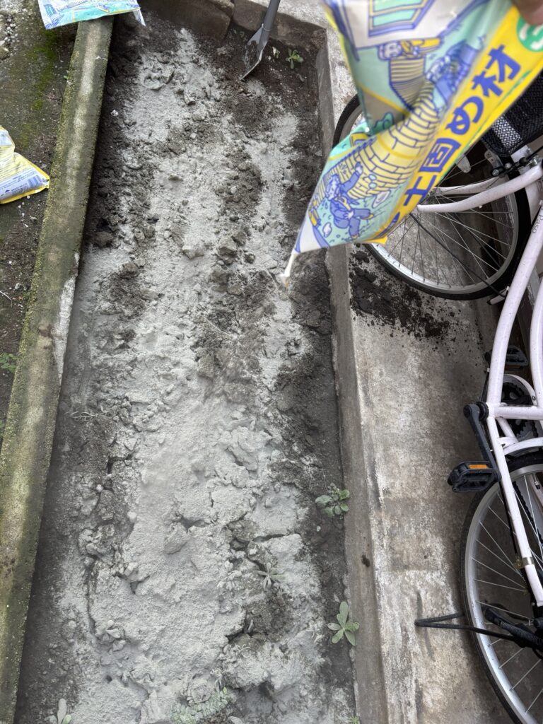 Soil stabilizer spread over the soil during preparation for a DIY concrete slab.