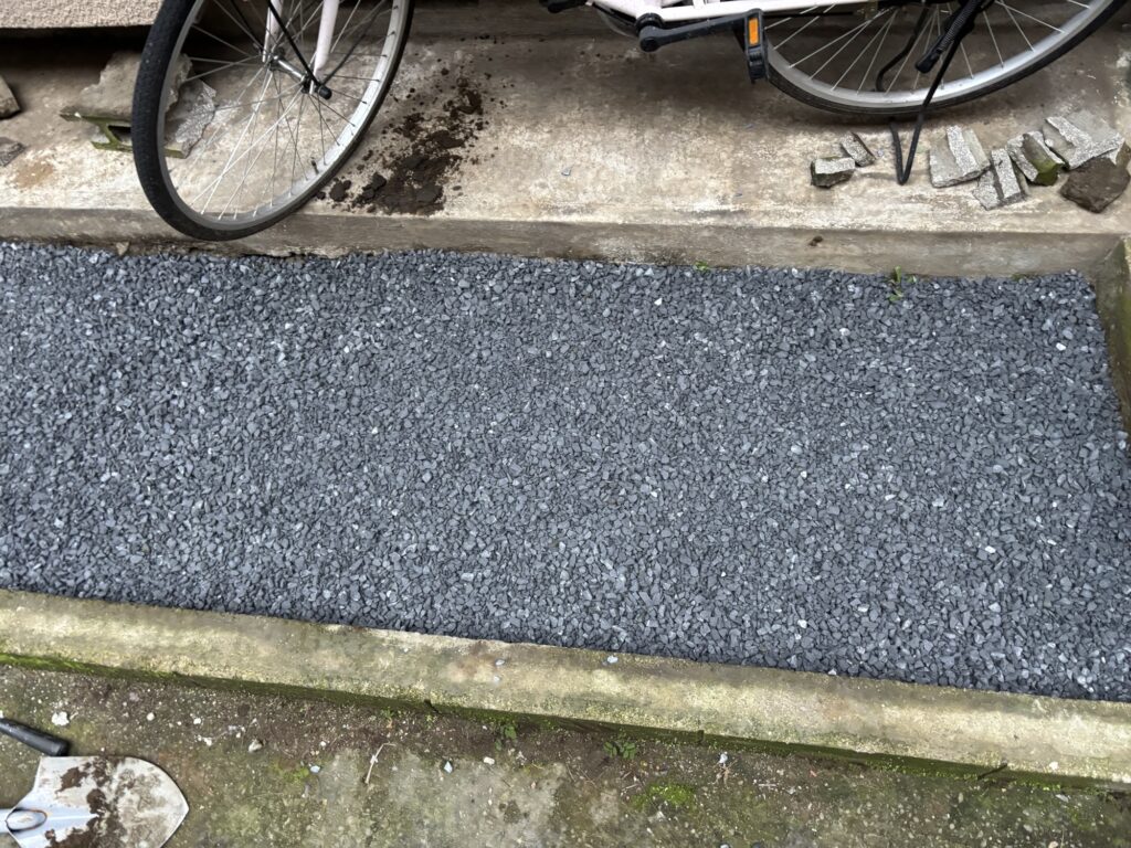 Crushed stone spread across the excavated ground for a concrete parking area.