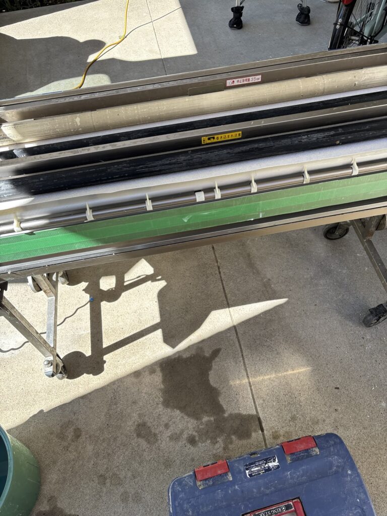 Wallpaper pasting machine used to apply adhesive to wallpaper during a kitchen renovation project.