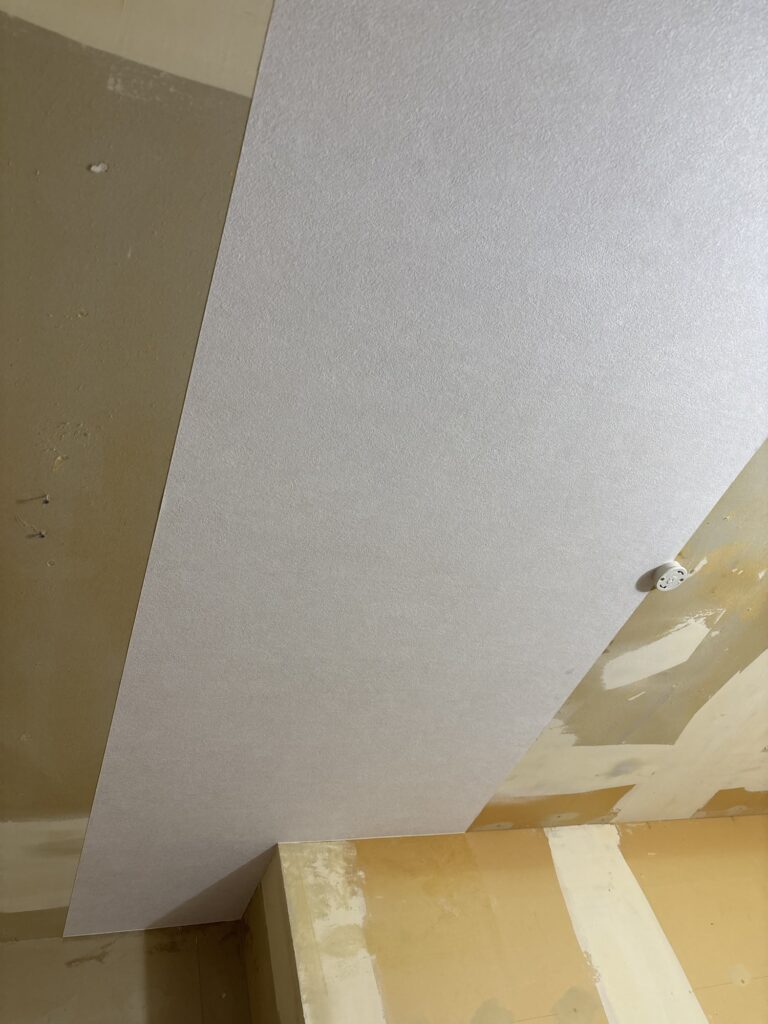 First sheet of new wallpaper installed on the ceiling of a Japanese kitchen.