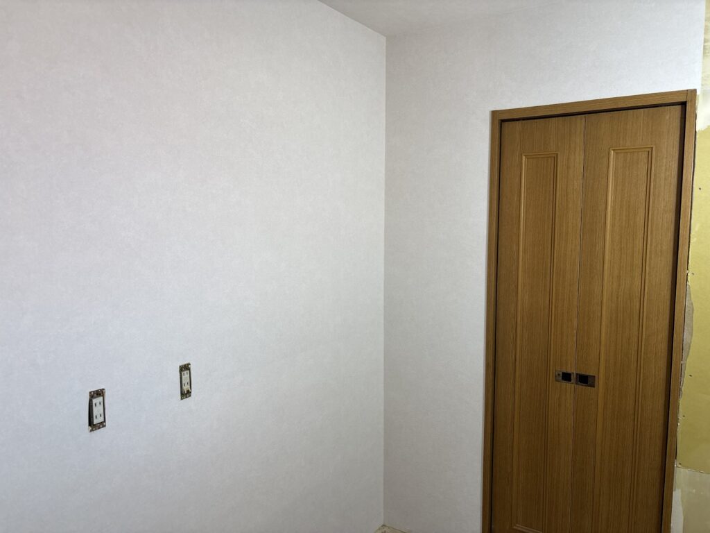 Completed wallpaper installation on the kitchen walls after surface preparation and professional installation.