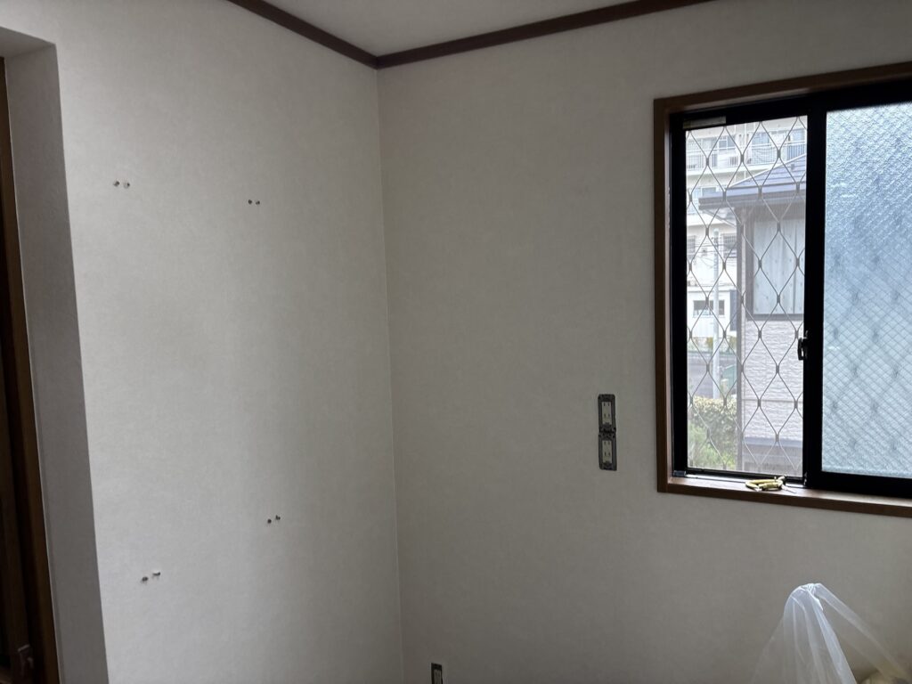 Finished wallpaper installation on the walls of a renovated Japanese washroom.
