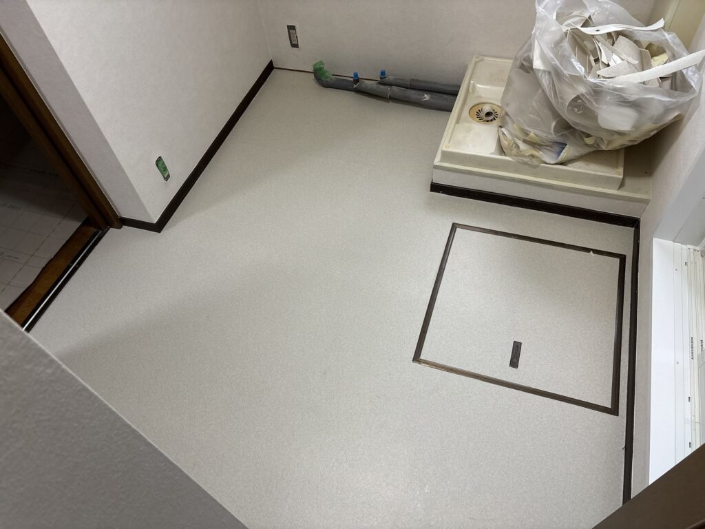 Finished gray cushion flooring installed in a Japanese washroom.