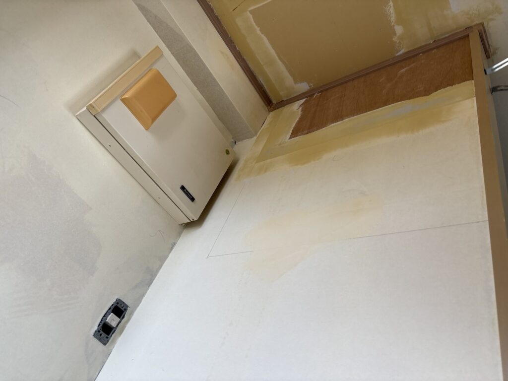 Ceiling surface with finishing joint compound applied before wallpaper installation.