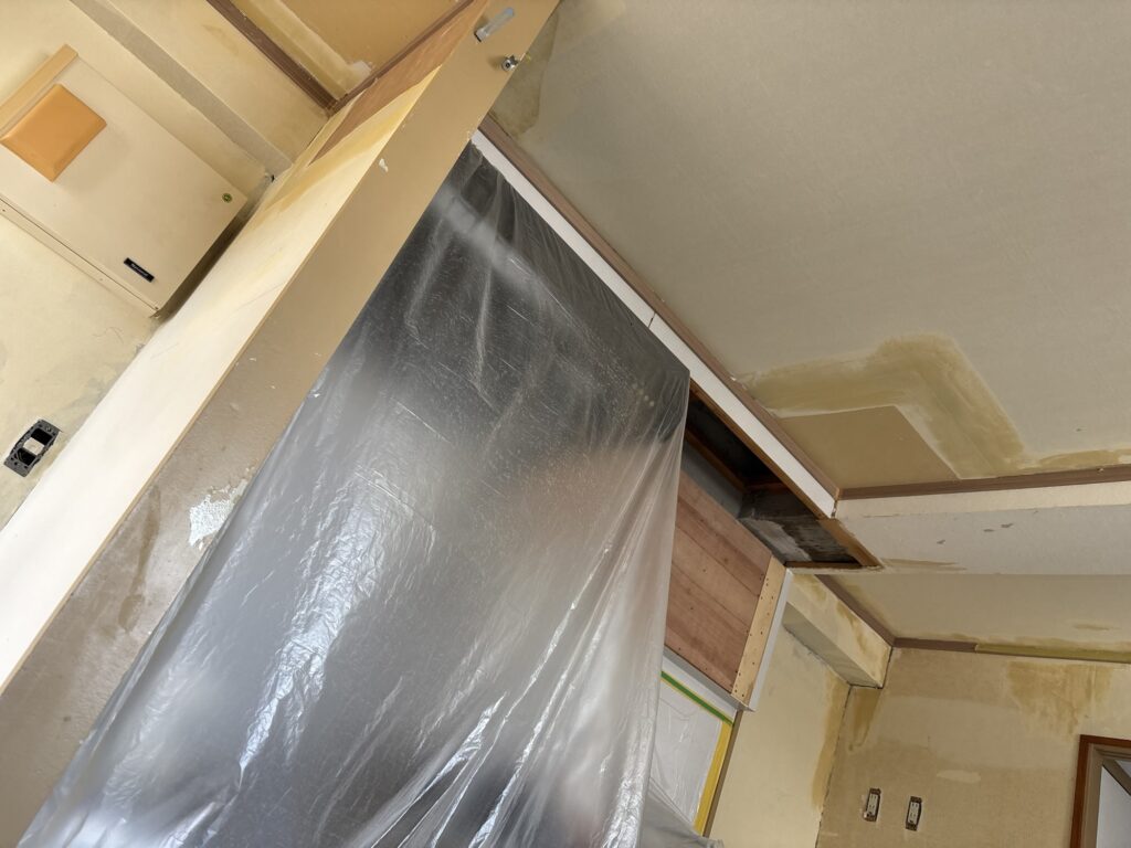 Prepared wall surface with finishing joint compound before wallpaper installation.