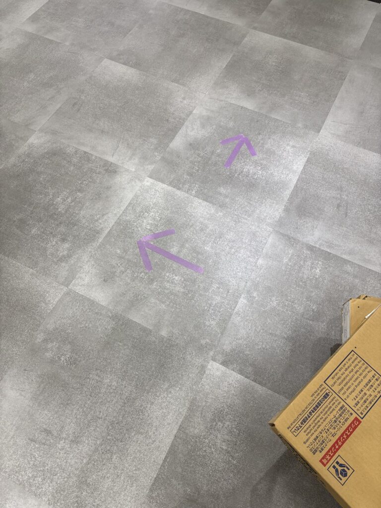Arrows showing the correct direction for installing new vinyl floor tiles.