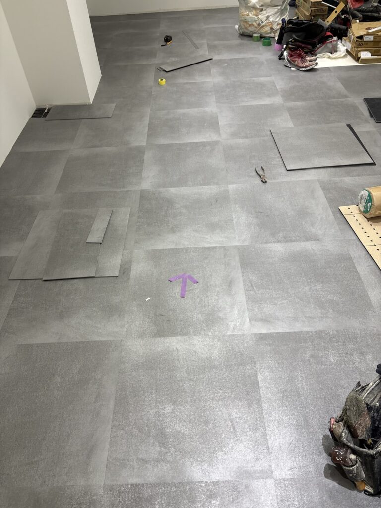 Vinyl tile replacement work in progress on the floor of a commercial store in Tokyo.