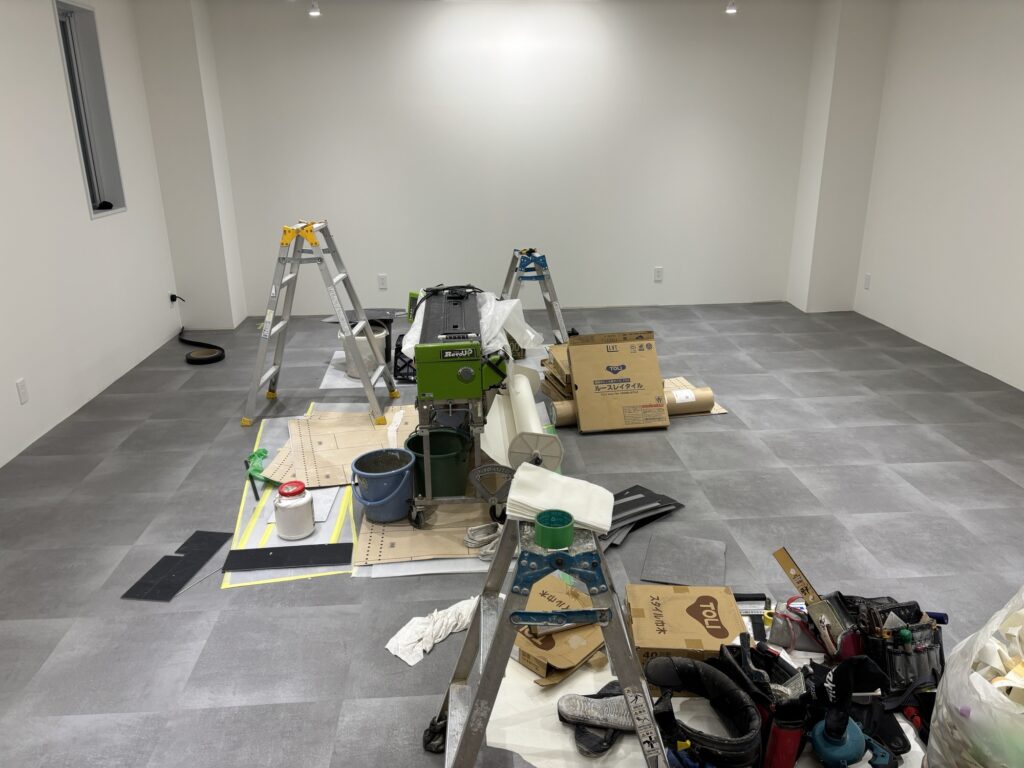 Completed gray vinyl tile flooring installation in a renovated commercial store.