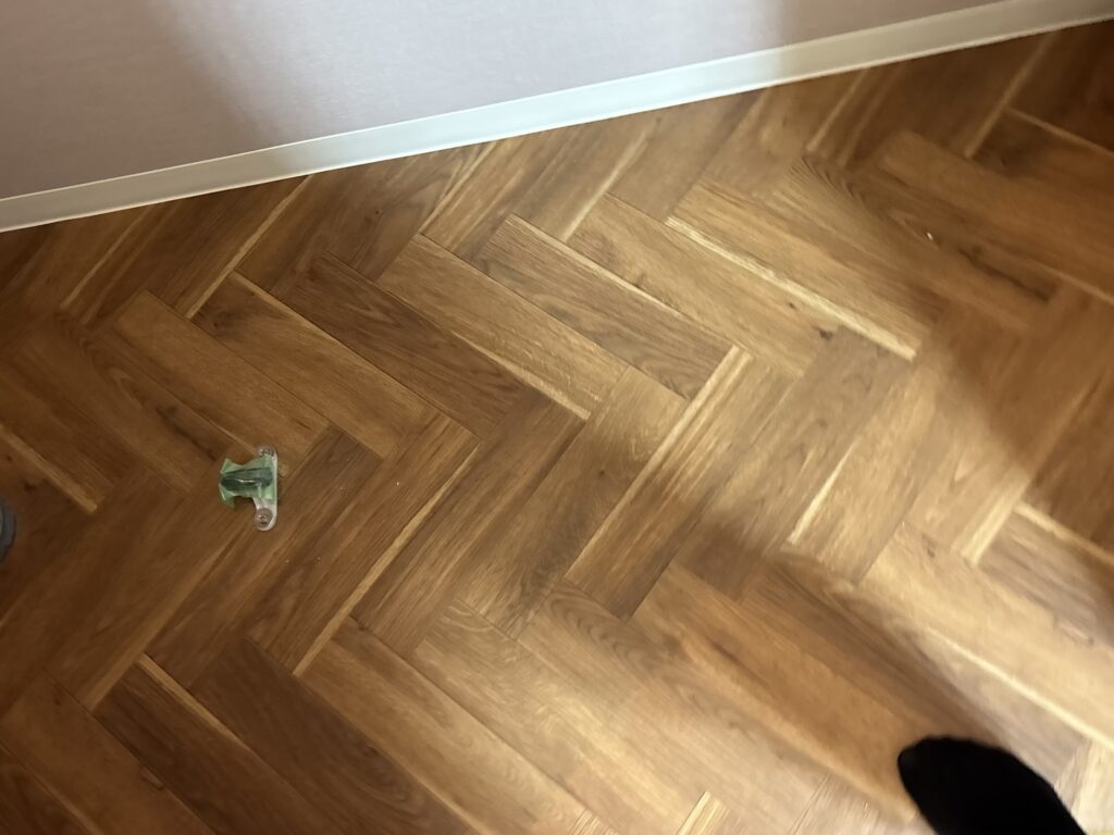 Completed herringbone pattern cushion flooring installed in the toilet of a Japanese apartment.