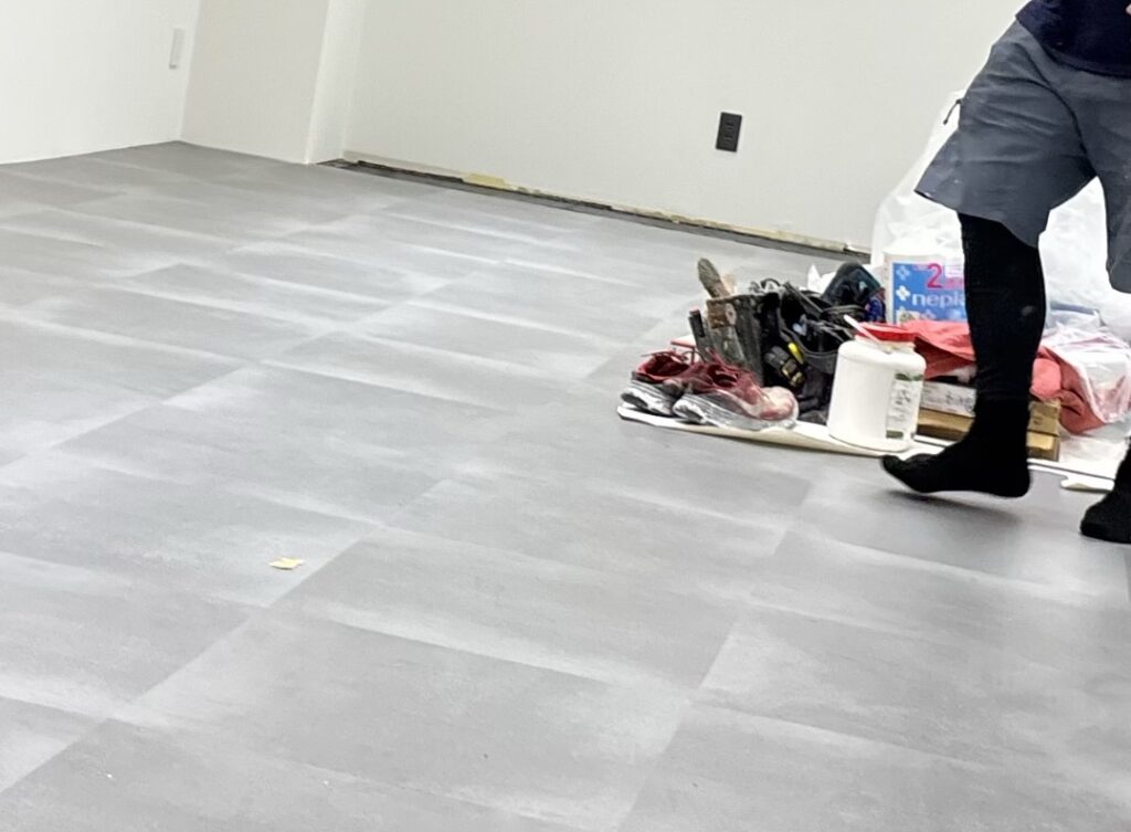 Close-up view of the completed floor tile installation showing the alignment and spacing between adjacent tiles.