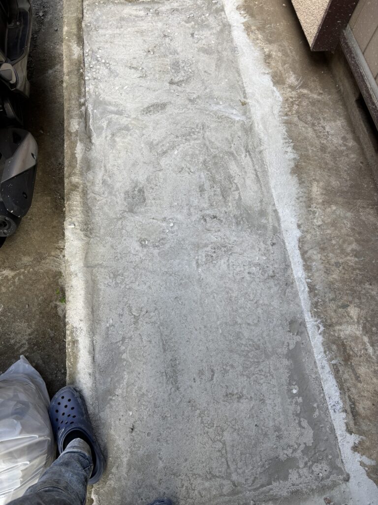 Newly poured concrete motorcycle parking area after the surface hardened overnight.