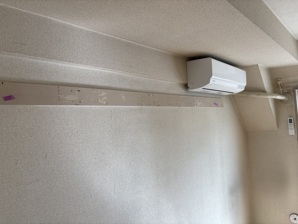 Traditional Japanese wooden wall rail installed along the upper wall of a condominium room before renovation.