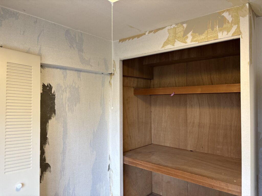 Living area in a condominium after old wall wallpaper has been stripped in preparation for new wallpaper installation.